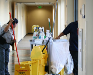 A man is cleaning the floor in an office building.